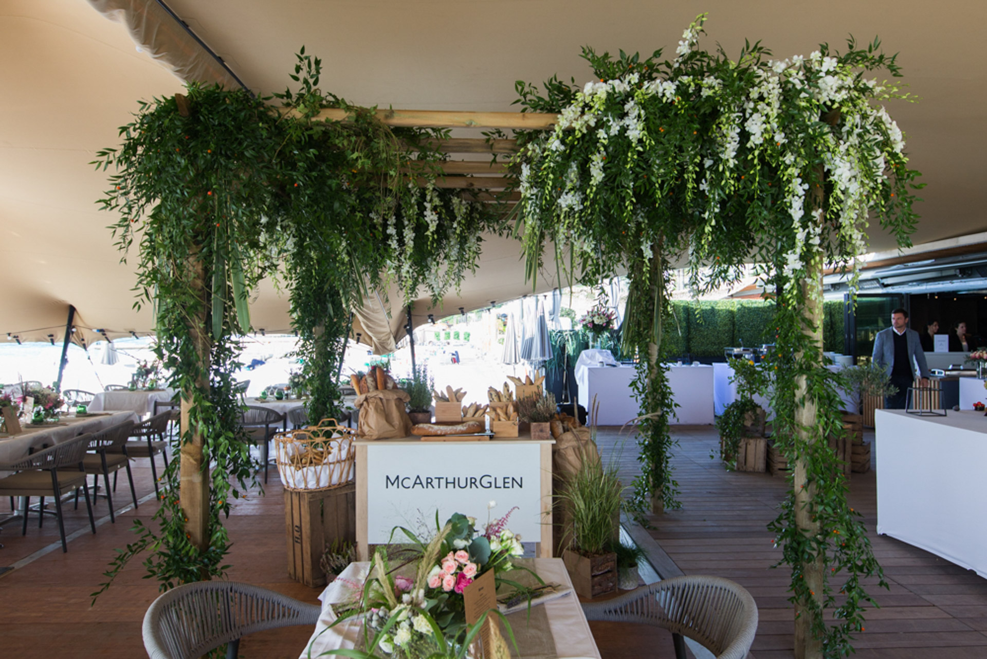 Table flowers and in the background floral canopy above the bread station under the berber tent during MAPIC networking lunch