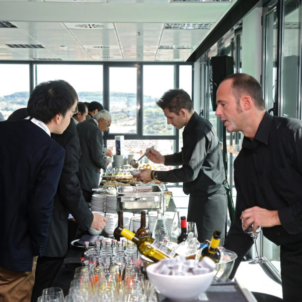 Waiter attending an attendee offering drink service upon guest arrival