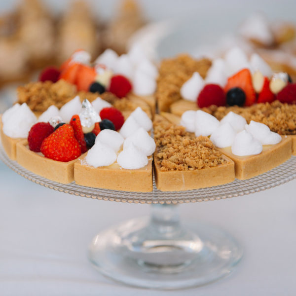 Dessert buffet tart with toppings such as red fruits chantilly crumble