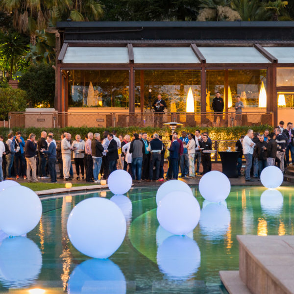 Swimming pool with lighted balloons during networking cocktail during corporate seminar in Barcelona