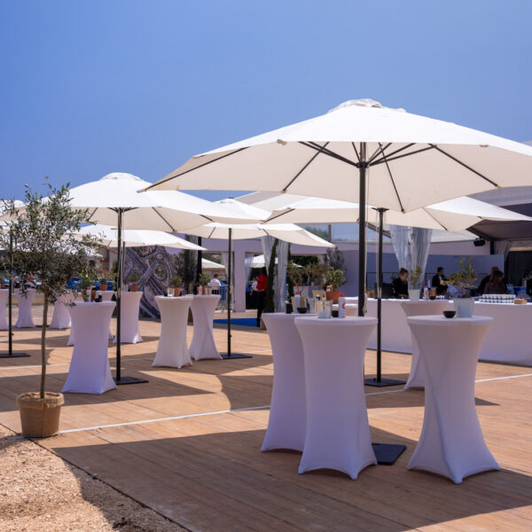 Terrace with umbrellas and high tables for the networking part of the inauguration