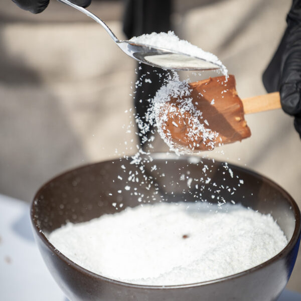 Ice cream show cooking during inauguration. Topping is being spread in front of the guests