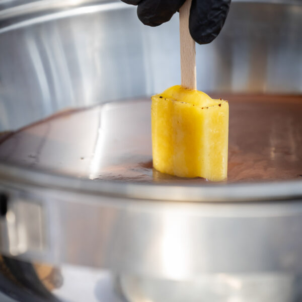 ice cream animation during a summer corporate event, the ice cream is dipped into melting chocolate