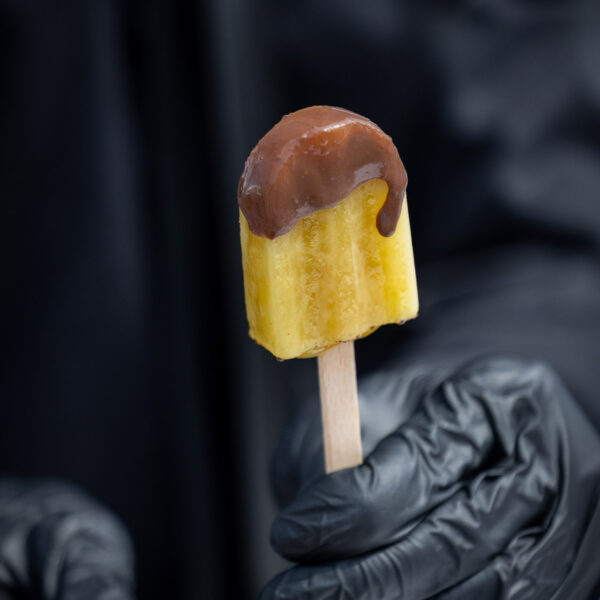 ice cream animation during a summer corporate event, the ice cream is dipped into melting chocolate