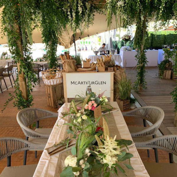 Table flowers and in the background floral canopy above the bread station under the berber tent during MAPIC networking lunch