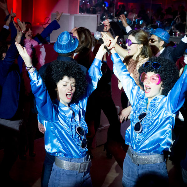 Disco girls dancing on the dancefloor during the theme party