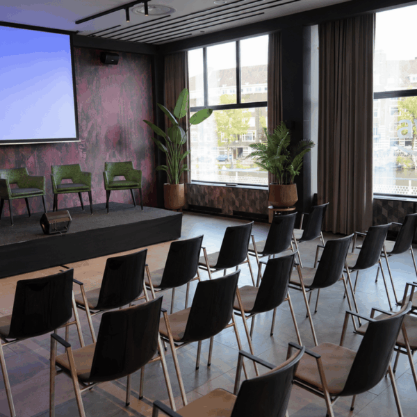 venue set up with theatre format facing the stage and the projection screen