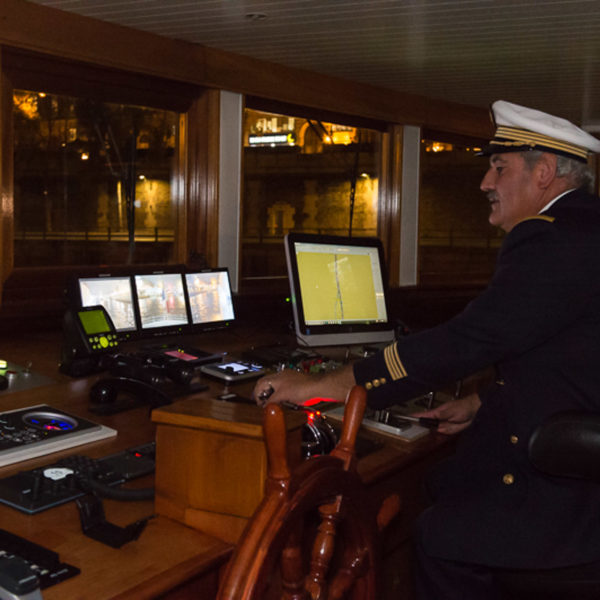 barge captain driving whil guest mingle after the conference