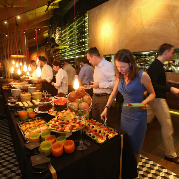 Buffet with guests selecting their food during networking dinner in the city center in Barcelona