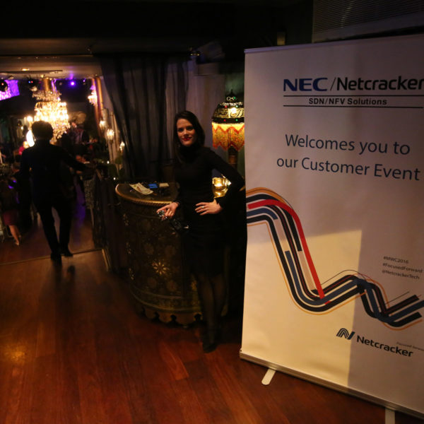 Venue entrance with branded roll-up banner and hostess to welcome guests and check the registered attendees during MWC evening