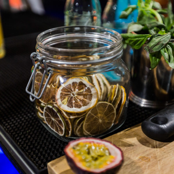 Dried lemon slices in jar during networking cocktail at MWC in venue facing the show