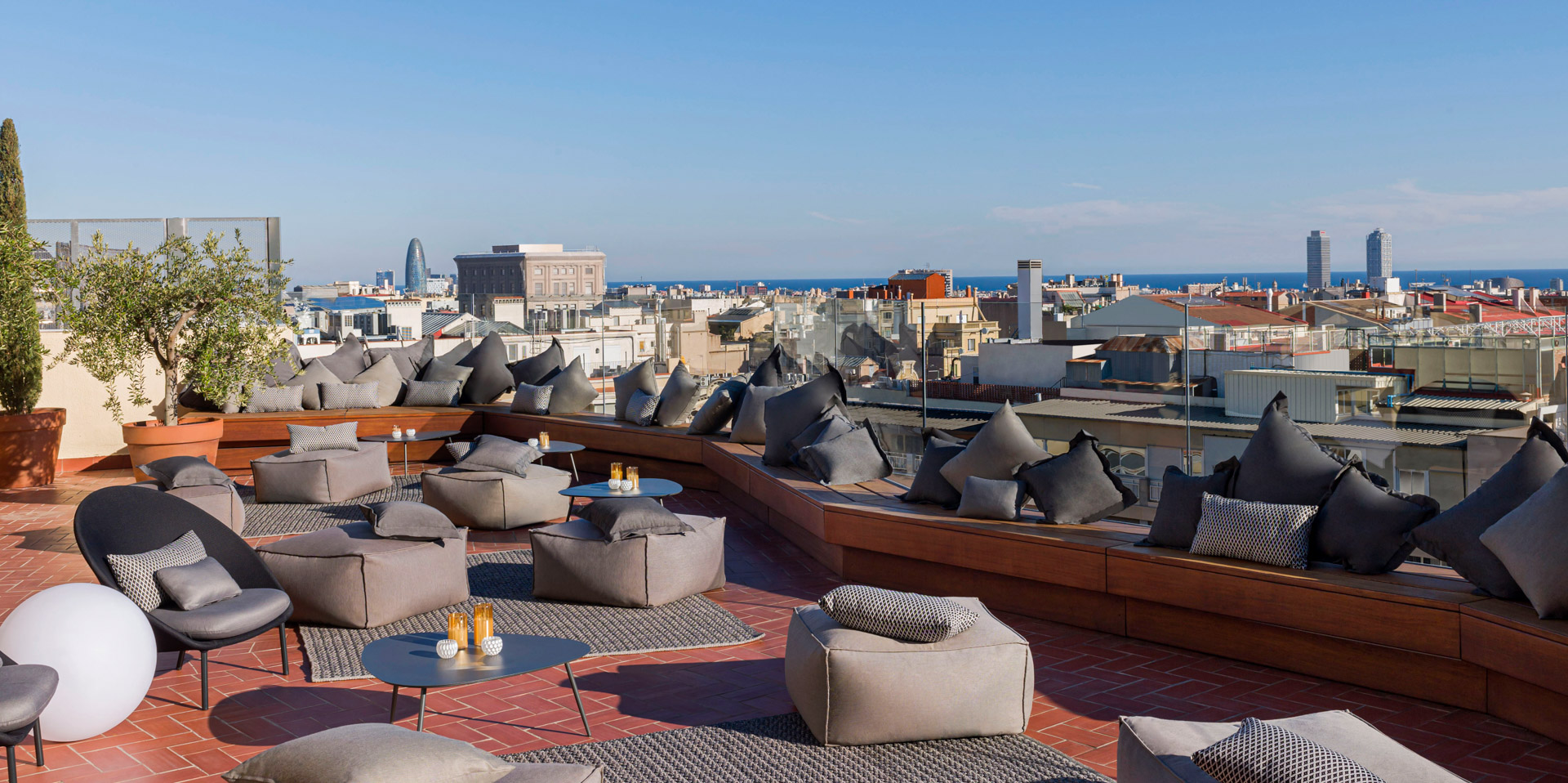 Lounge set-up on the rooftop terrace facing the sea in barcelona