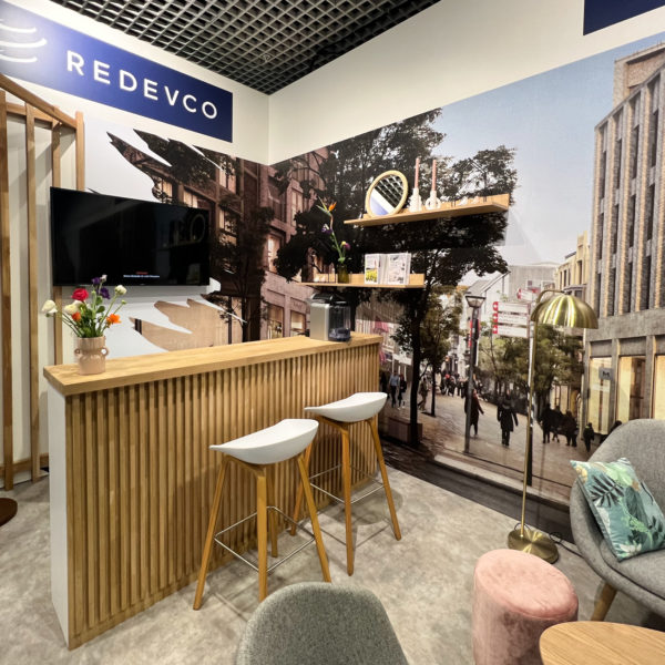Wooden welcome desk with printed walls on the booth in Cannes