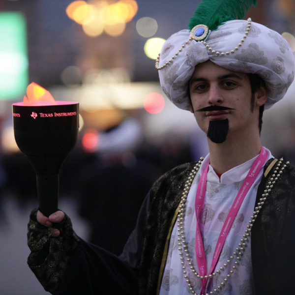 maharaja dressed up actor with branded torch to lead the way towards the venue at the exit of MWC congress in Barcelona