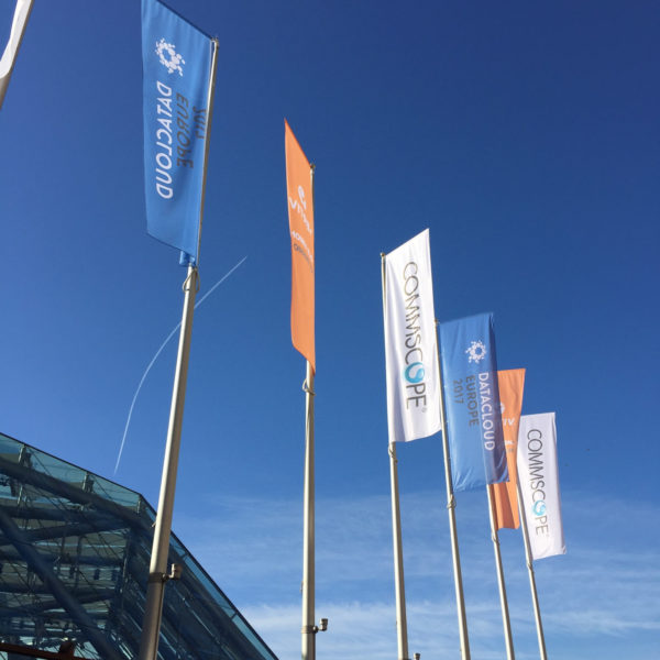 flags with customer branding in front of the grimaldi forum during datacloud global congress