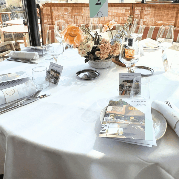 Table all set for MIPIM lunch from rooftop with branded menus and table names