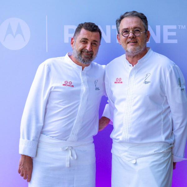 The two michelin star chef posing in front of the photocall with his team member