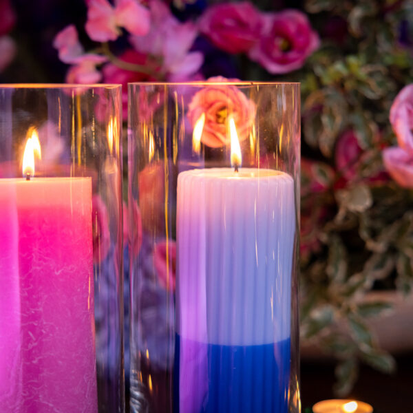 Candles lighting up the venue with flowers in the background