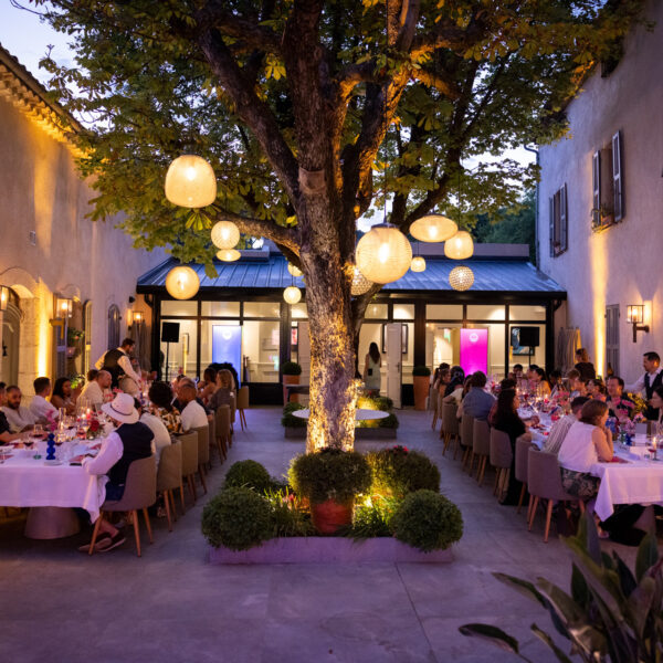 Venue overview, outdoor dinner with trees, lights and very charming environment for a high level dinner for content creators during Cannes Lions