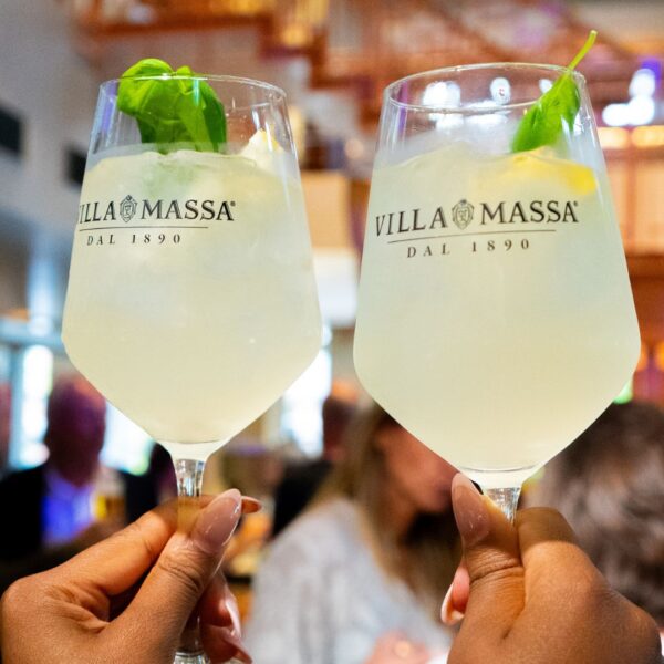 Limoncello spritz glasses with basil leaf, a very refreshing drink served to the guests during the happy hour