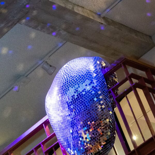 artsy disco ball melting like dali's clocks with blue lighting