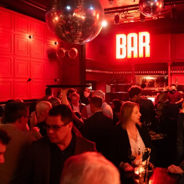 Venue overview packed with guests mingling during the happy hour in Amsterdam