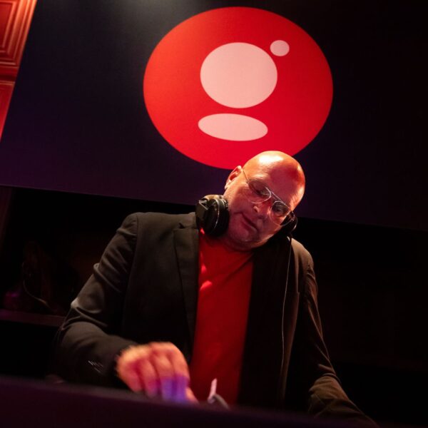 DJ from the front with the branding performing during the evening in the private club in Amsterdam during IBC