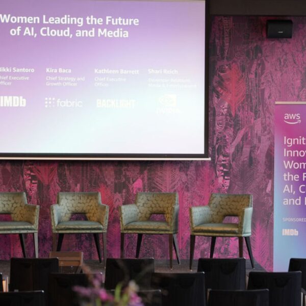 stage from upclose with the projection screen slide and the panelists chairs before the event starts