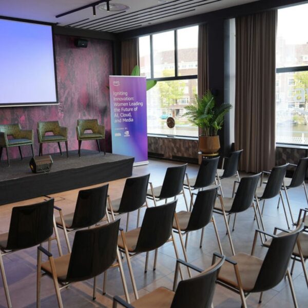 venue set up with theatre format facing the stage and the projection screen