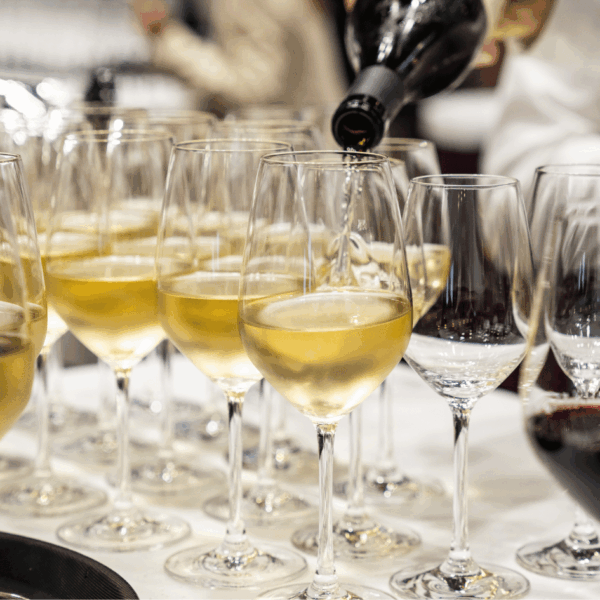 White wine served in glasses to prepare a tray to pass around during the happy hour at the booth