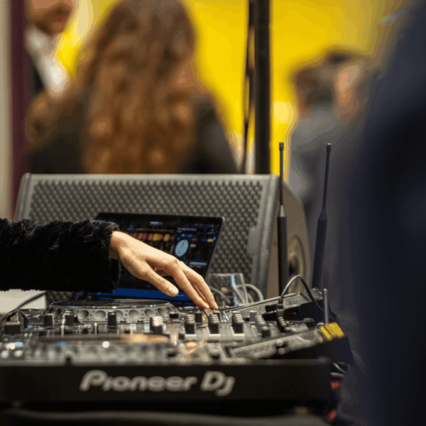 DJ woman while playing music during the Expo real networking event at the stand