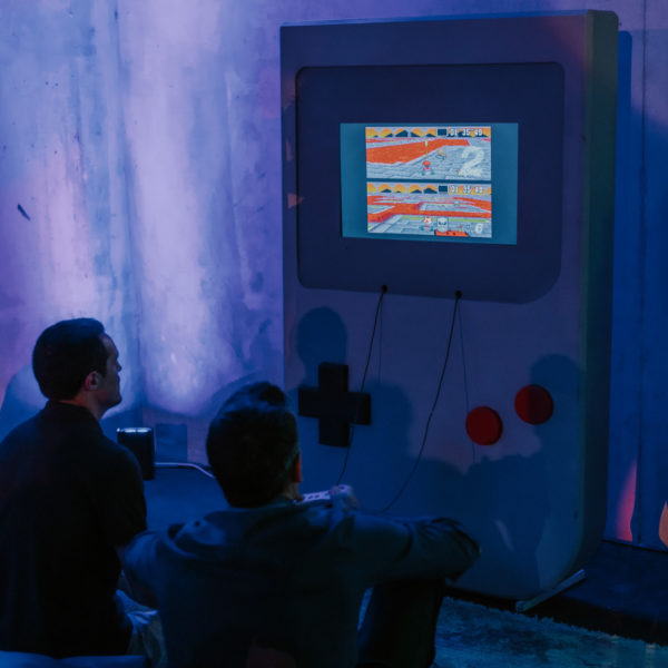 Guests playing Super mario kart with the giant game boy during the corporate event