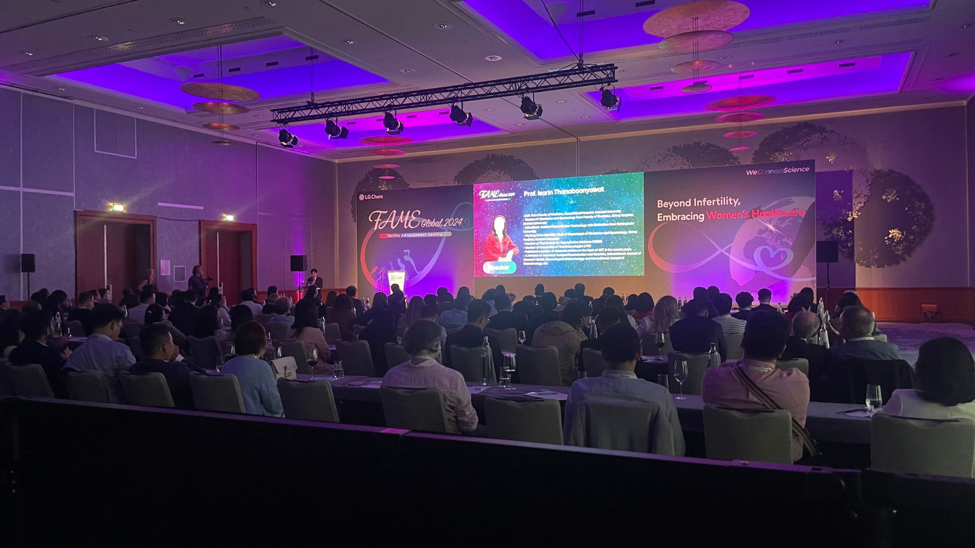 global view of the medical conference room including classroom tables for 130 pax a 17 meters stage a 5,5 meters LED screen and beautiful purple lighting