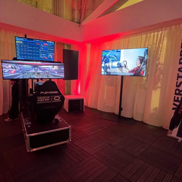 Formula one simulator palced within the covered terrace for the networking event at the end of the industry summit