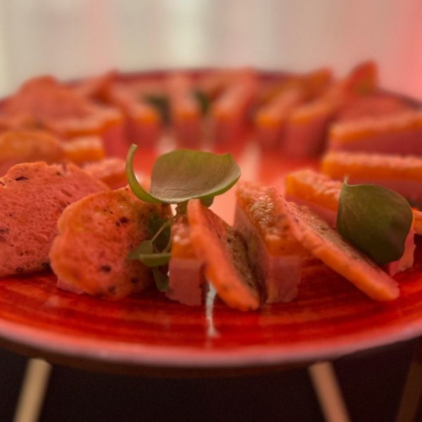 Foie gras finger food on plate during the networking event at the end of the industry summit