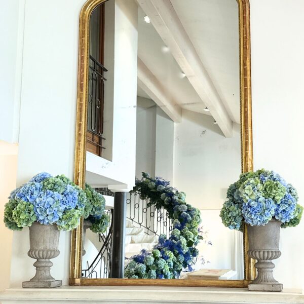 Mirror with a ramp of flowers going up the staircase in reflection