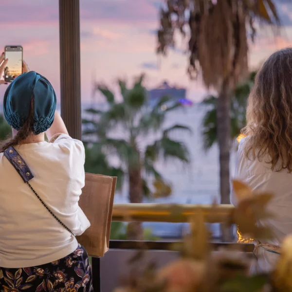 guests on the terrace during the networking event taking pictures of the view of the croisette at sunset