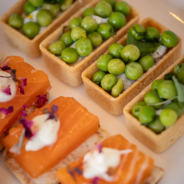 cockail pieces close up view, peas and salmon canapés refinely presented