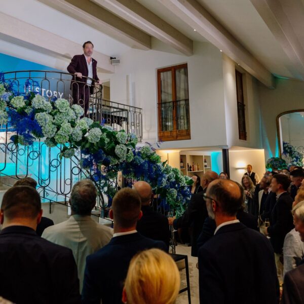 the CEO speaking from the top of the duplex facing the audience downstairs