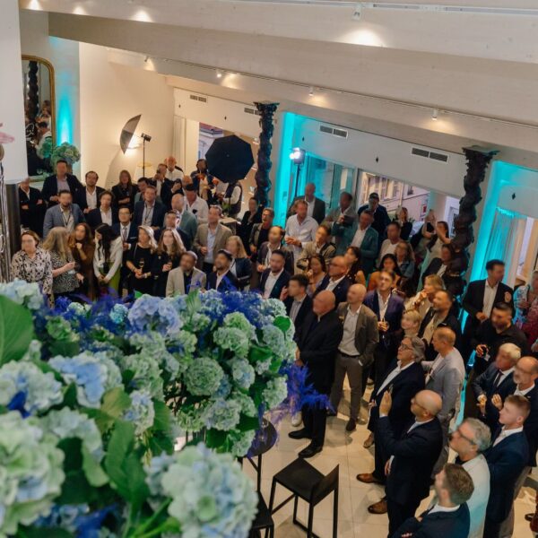 the CEO speaking from the top of the duplex facing the audience downstairs