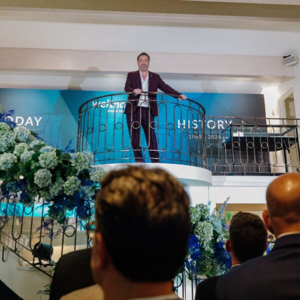 the CEO speaking from the top of the duplex facing the audience downstairs