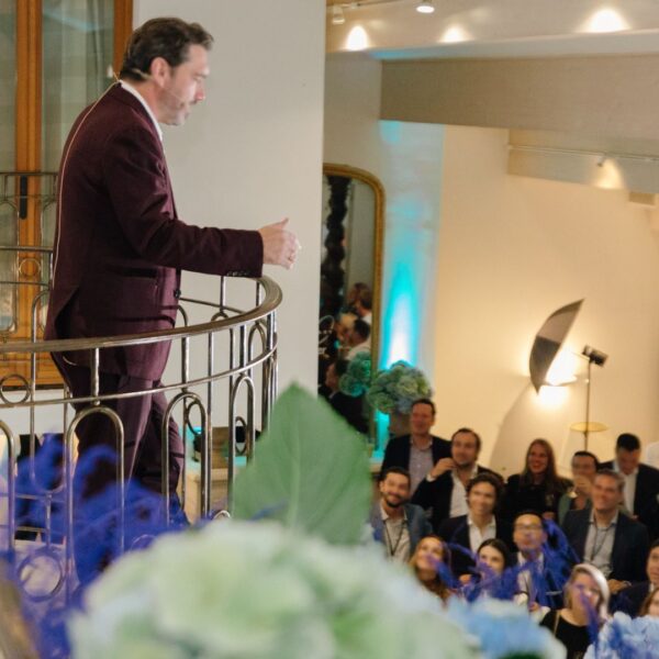 the CEO speaking from the top of the duplex facing the audience downstairs